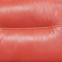 red leather backrest couch with sewings