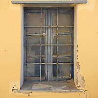 old barred window with stone frame 13
