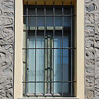 old barred window with stone frame 14