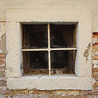old barred window with stone frame 15