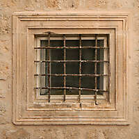 old barred window with stone frame 4