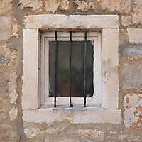 old barred window with stone frame 6