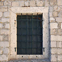old barred window with stone frame 7