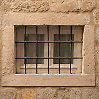 old barred window with stone frame 9