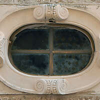 rounded old medieval window with grate 11