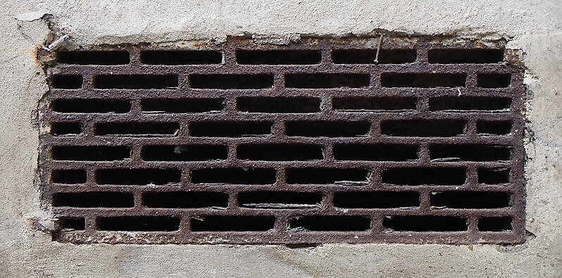 rusty sewer manhole square holes