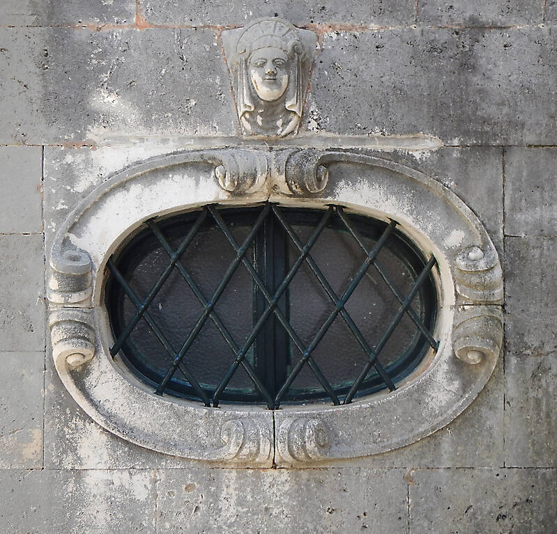 rounded old medieval window with grate 12