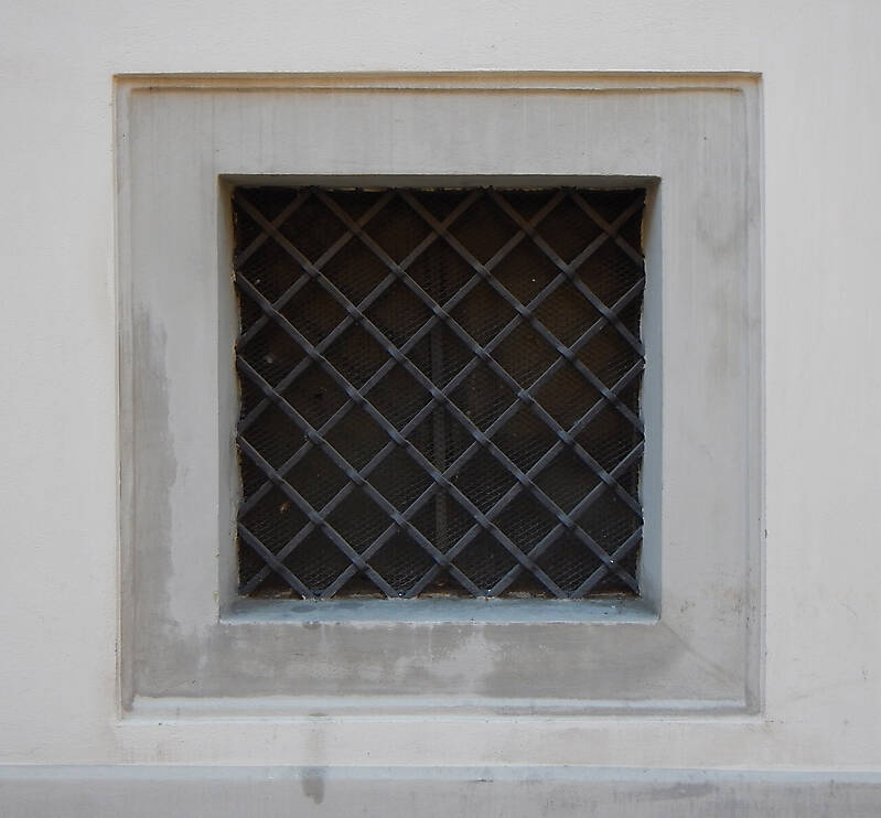 old barred window with stone frame 3