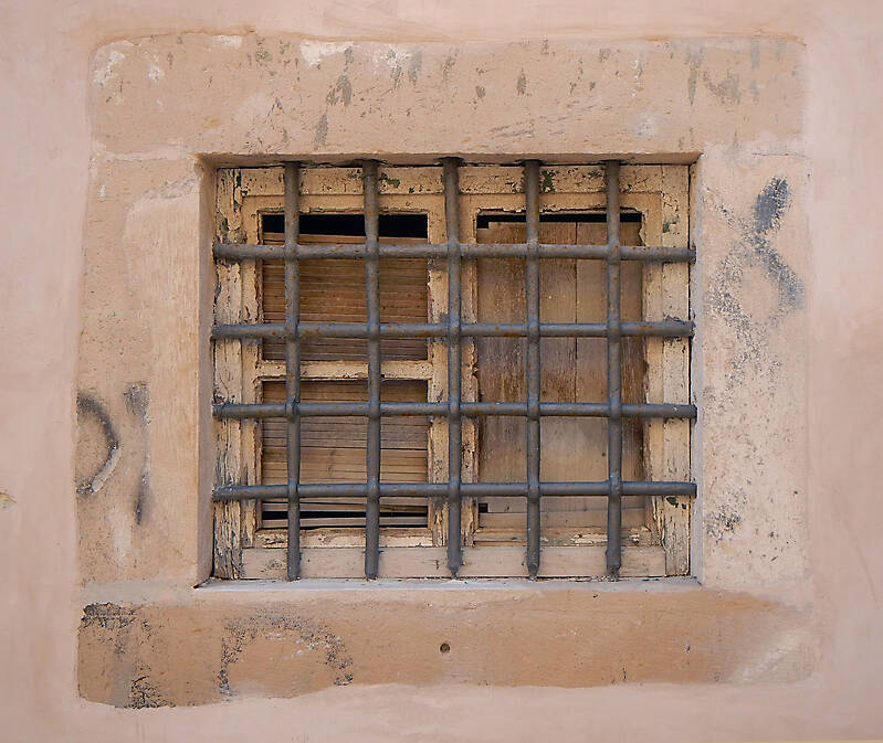 old barred window with stone frame 5