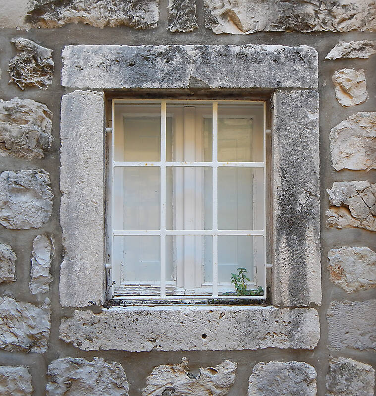 old barred window with stone frame 8