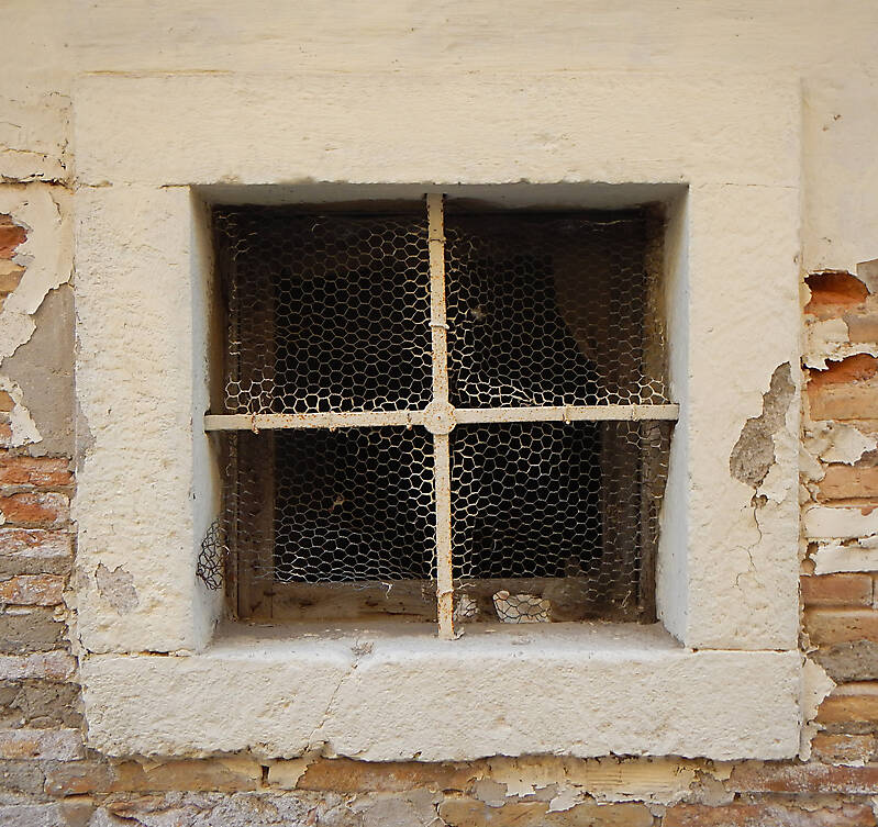 old barred window with stone frame 15