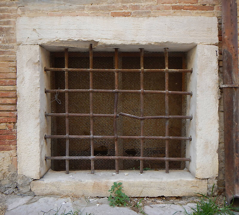 old barred window with stone frame 16